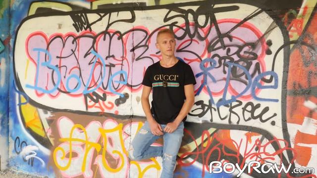 Teen boy touches himself openly near painted walls