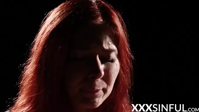 Redhead babe gives passionate blowjob in romantic setting