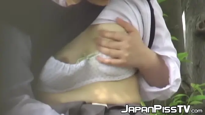 Japanese schoolgirl touching herself before peeing outside