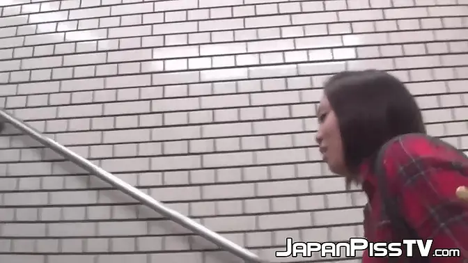 Asian babe pees in her skirt in public