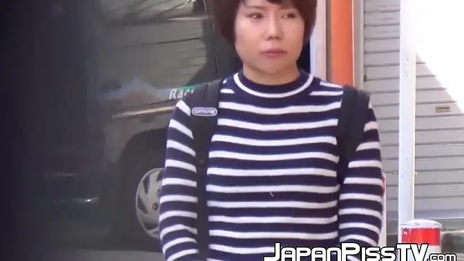 Dark-haired Asian babe pees in her knickers