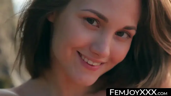 Teen girl teases with her bare pussy at the beach