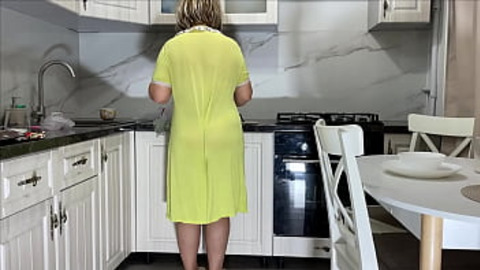Stepmom has fun with her stepson in the kitchen while her husband is not home