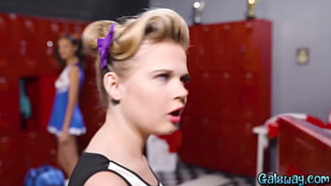 Two cheerleaders taking turns squirting all over the locker room
