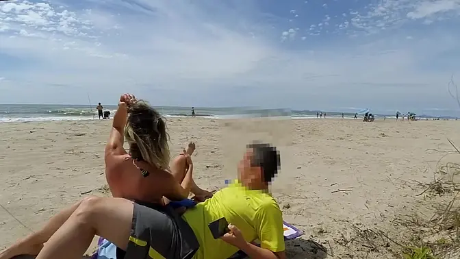 Beach MILF gives giant cock handjob and cums with it