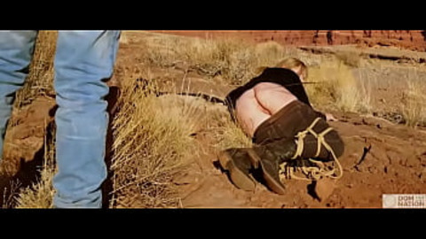 Submissive babe gets an asshole whipping before getting butt fucked on pee-covered ground -- a hard, genuine domination adventure out in nature (Rebel Rhyder)