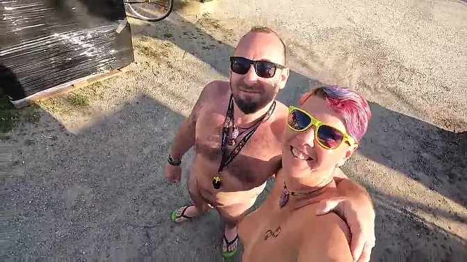 Amateur wife shows off short hair and natural tits at nudist gathering