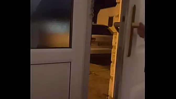 Exhibitionist MILF spreads her wet pink pussy in front of an open door