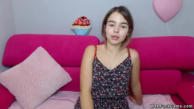 Charming teen brunette in colorful dress on cam