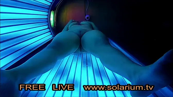 Hidden webcam catches busty blonde in public solarium