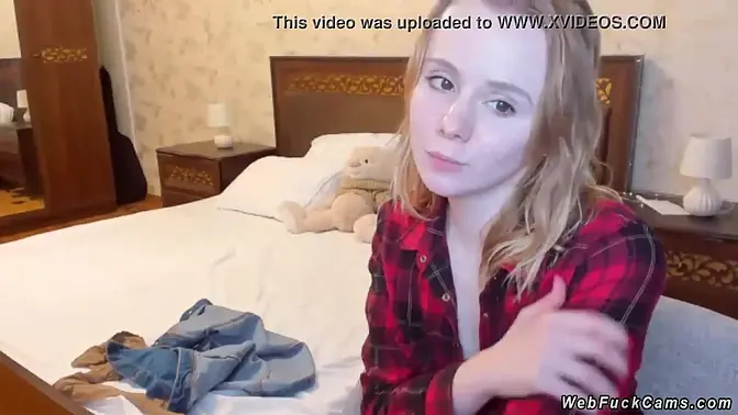 Petite blonde webcam babe shows off in black bra and red shirt