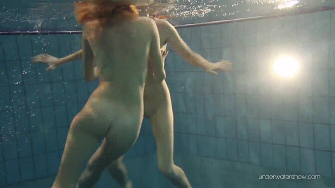 Two hot lesbian babes enjoy a swim in the pool