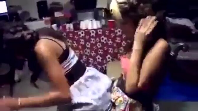 Two hot lesbo babes engage in a steamy lap dance session, their bodies