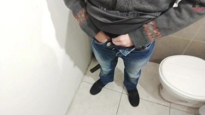 Young Hispanic man plays with big uncut cock in bathroom