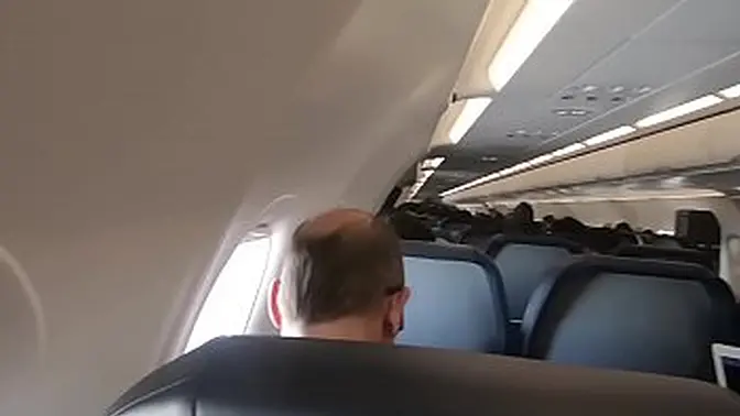 Teen brunette gets blowjob on public airplane