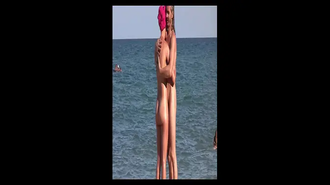 Two nude babes sunbathe on the beach