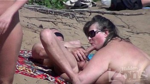 Getting a sloppy blowie while watching naked beach babes get down