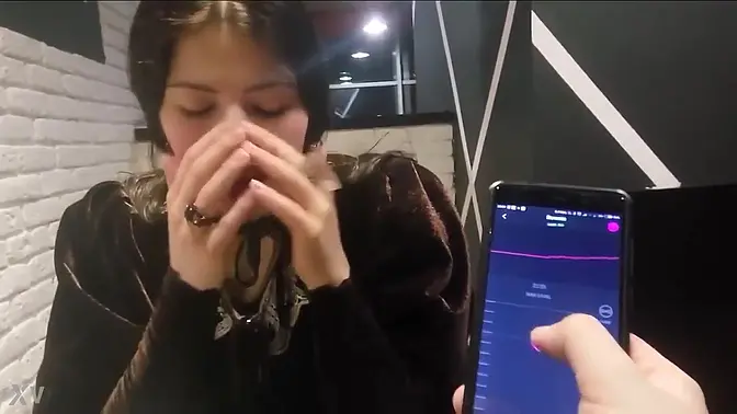 Girl gets teased with Ohmibod at restaurant