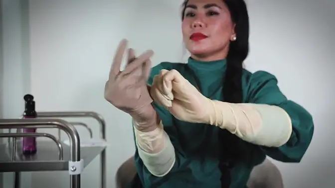 Nurse strips off rubber gloves while teasing with medical tools