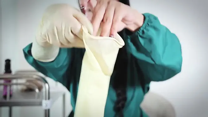 Nurse strips off rubber gloves while teasing with medical tools