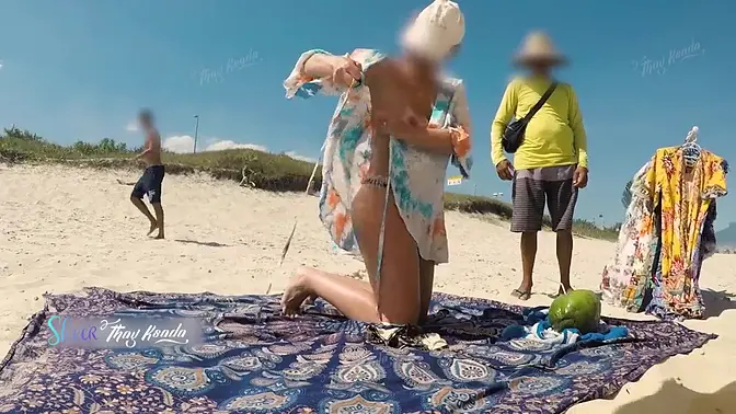 Sultry Latina milf flashes large tits for beach vendor