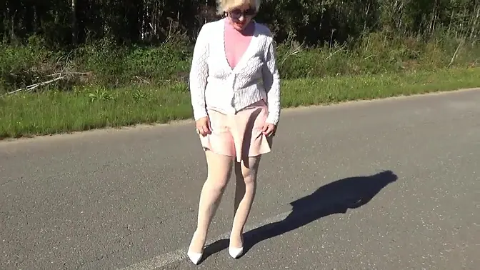 Beautiful blonde MILF in glasses teases with pantyhose-clad legs