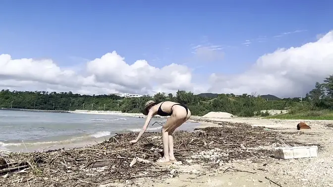 Beautiful blonde in sundress worships the beach