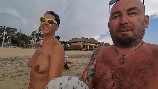 Short-haired wife shows off natural tits at the beach