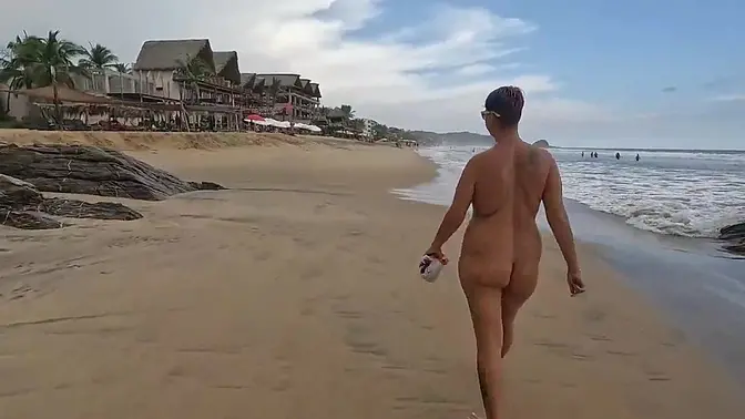 Short-haired wife shows off natural tits at the beach