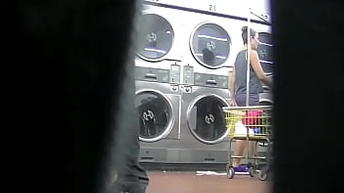 Slutty MILF flashes upskirt at young man in laundry
